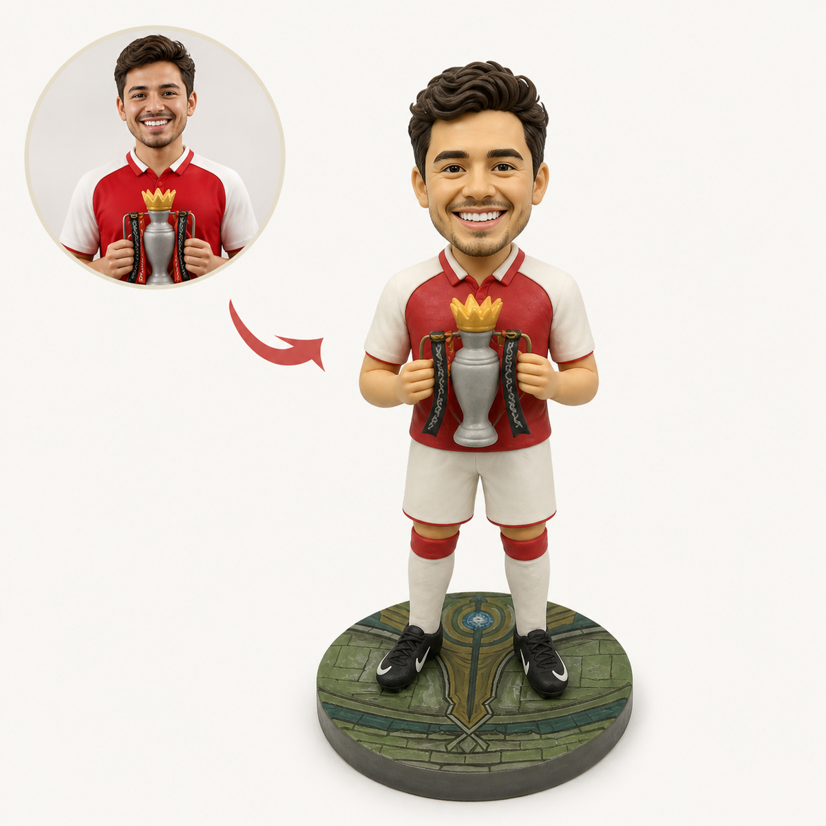 A footballer holding the trophy, sculpted on a pitch base