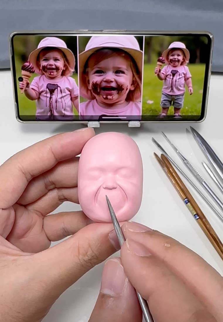 An artist shaping the basic head from a customer photo