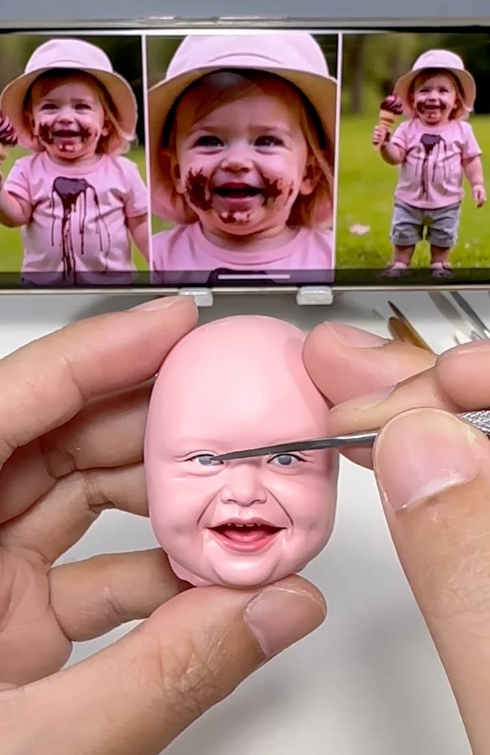 Hand-painting the head in the chosen skin and eye colour