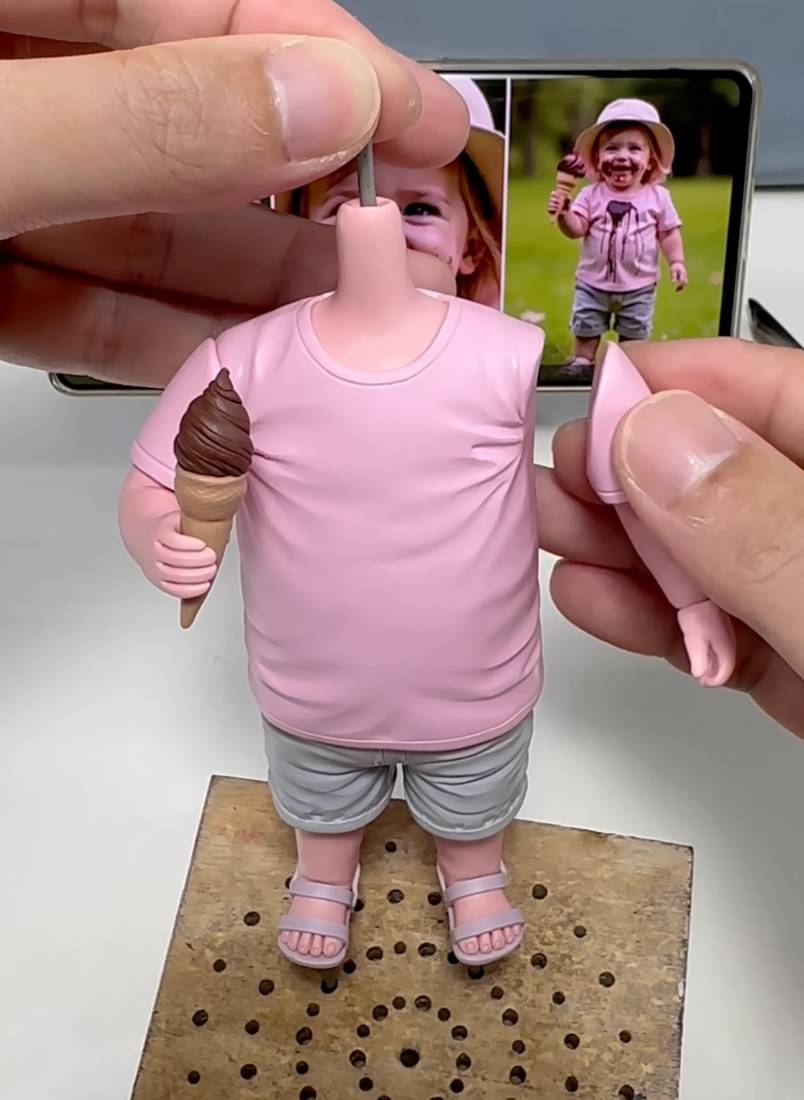 The finished figurine beside the photo it was sculpted from