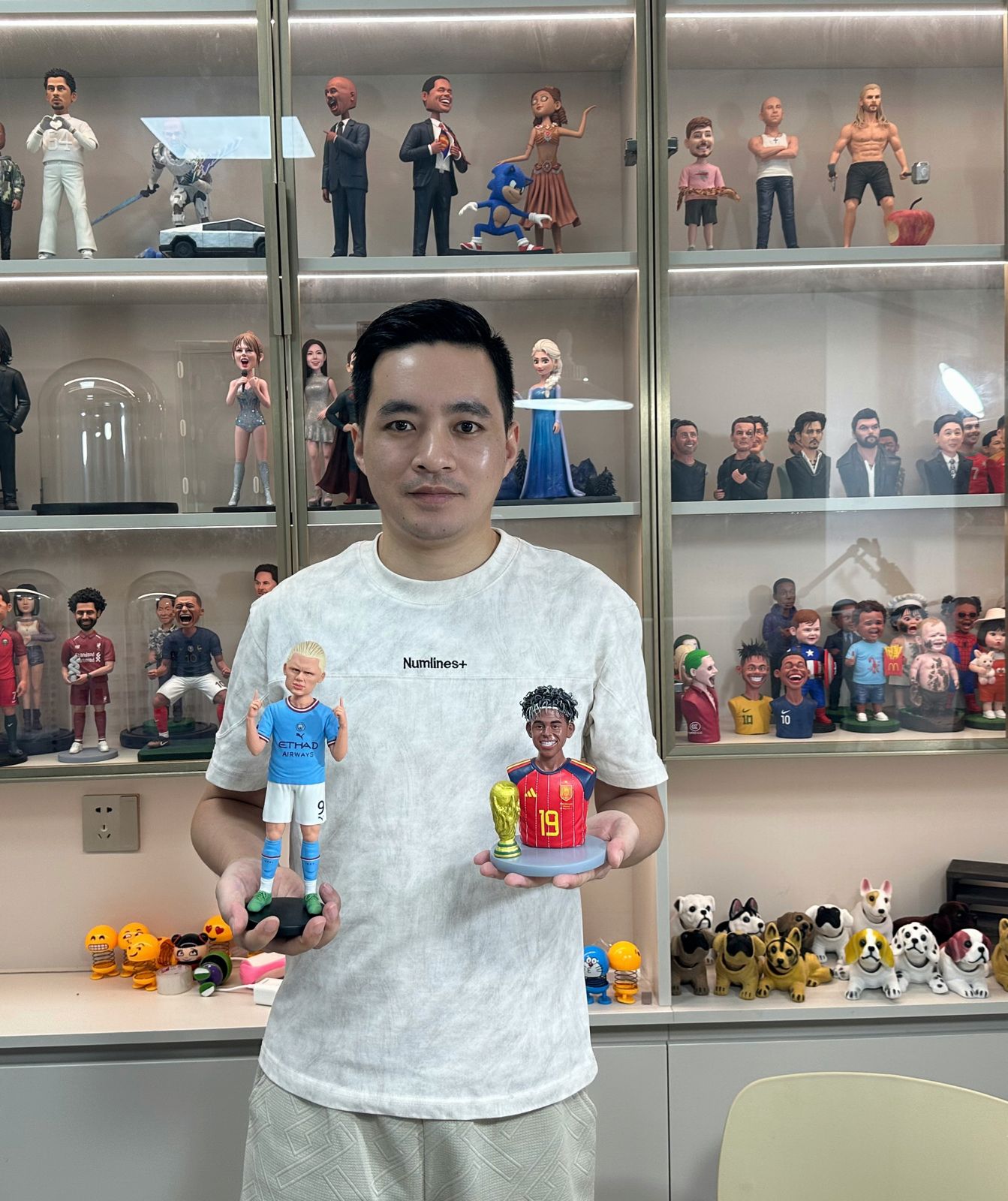 Jay in his studio, holding the Haaland and Lamine Yamal figures